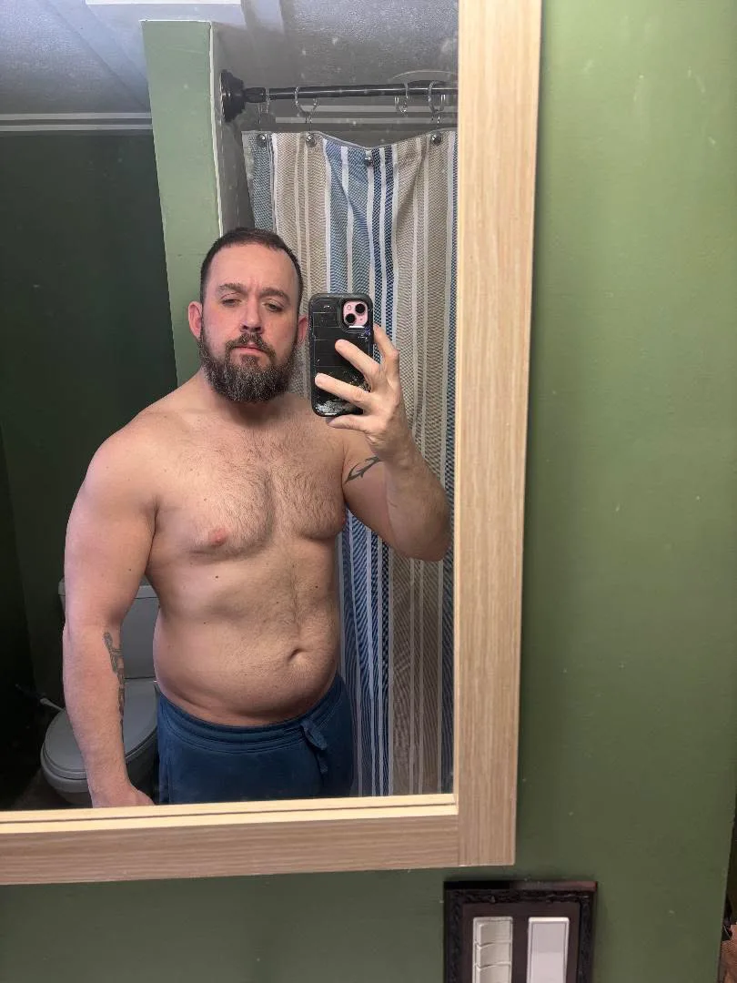 Client photographed in a bathroom mirror at the start of coaching