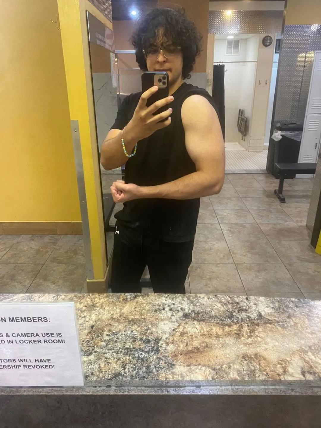 George in the gym mirror earlier in coaching, flexing his left arm