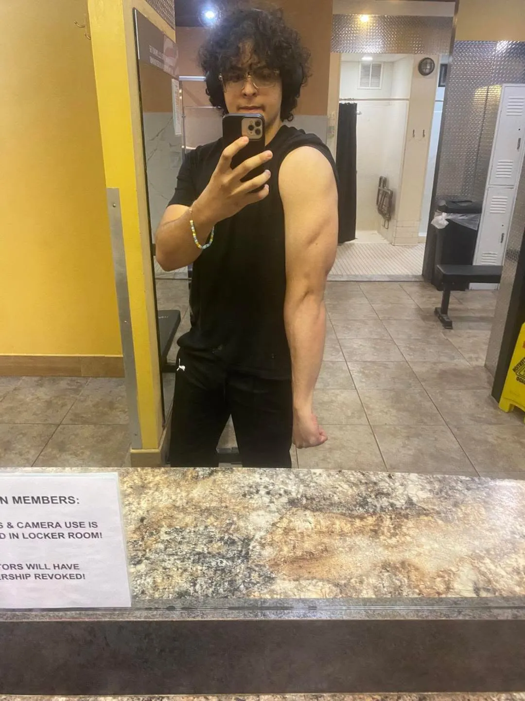 George in the gym mirror earlier in coaching, flexing his right arm