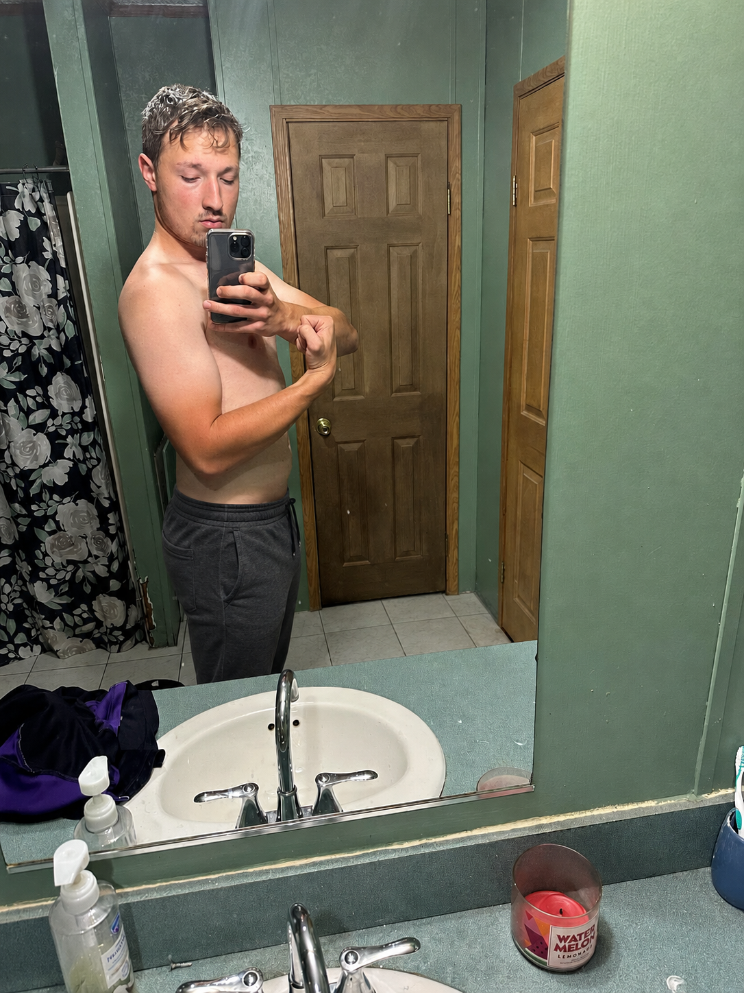 A second client photographed in a bathroom mirror at the start of coaching